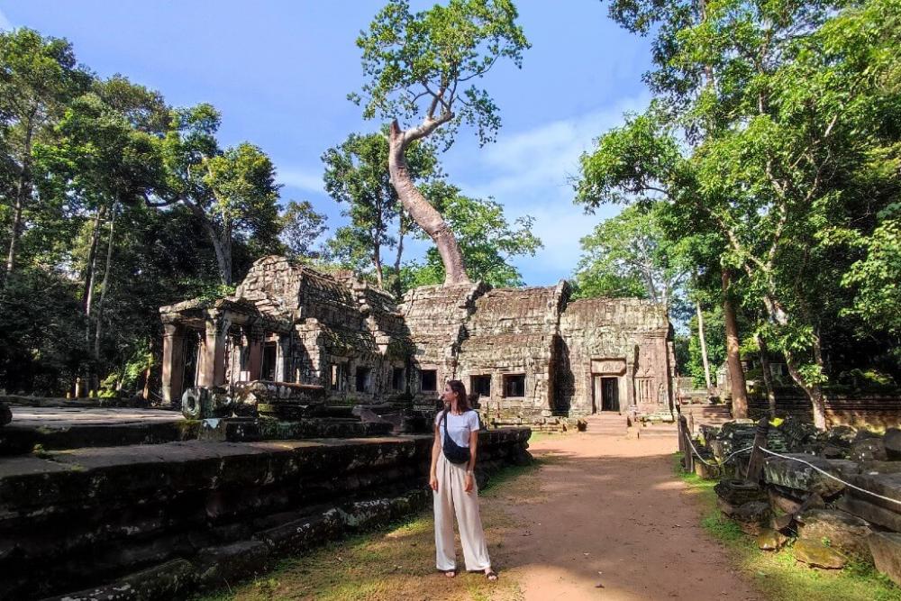 une voyageuse solo devant le temple Ta Prohm au Cambodge