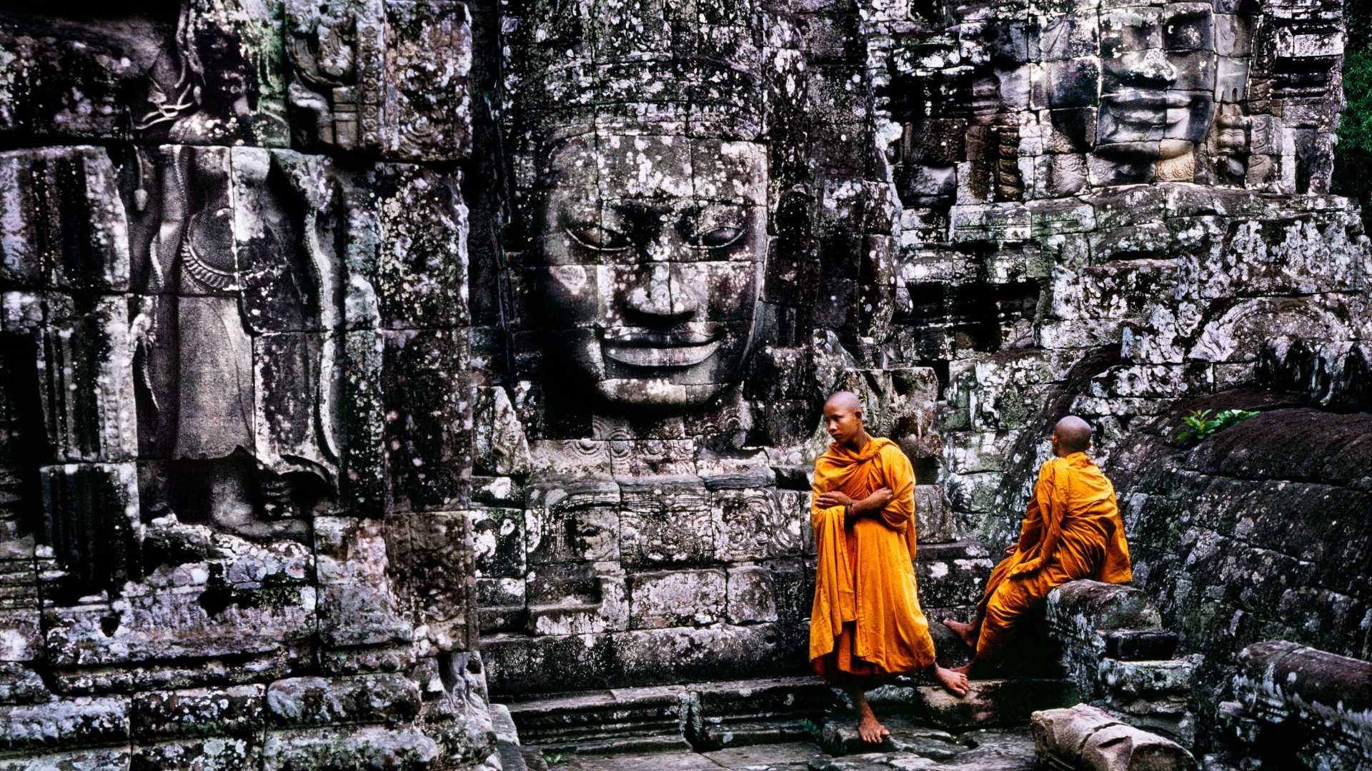 voyage cambodge, siem reap, bayon, moines devant une statue de visage